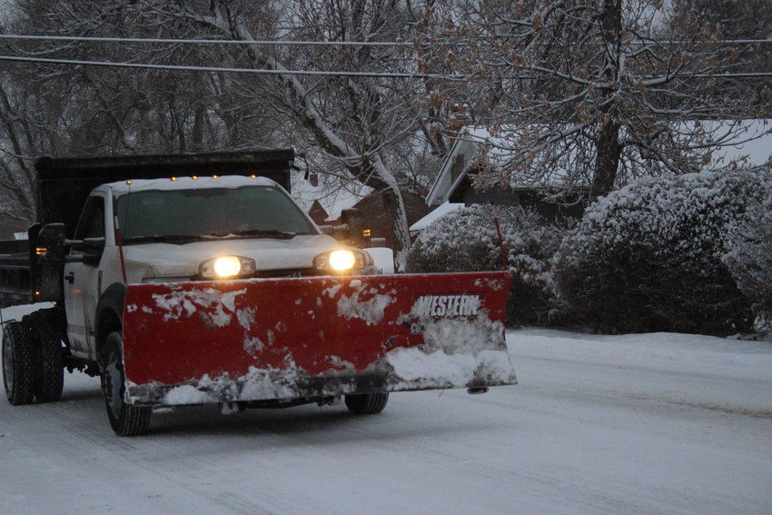 A snow plow rolls down a Lakewood street during the Feb. 7 snow storm.